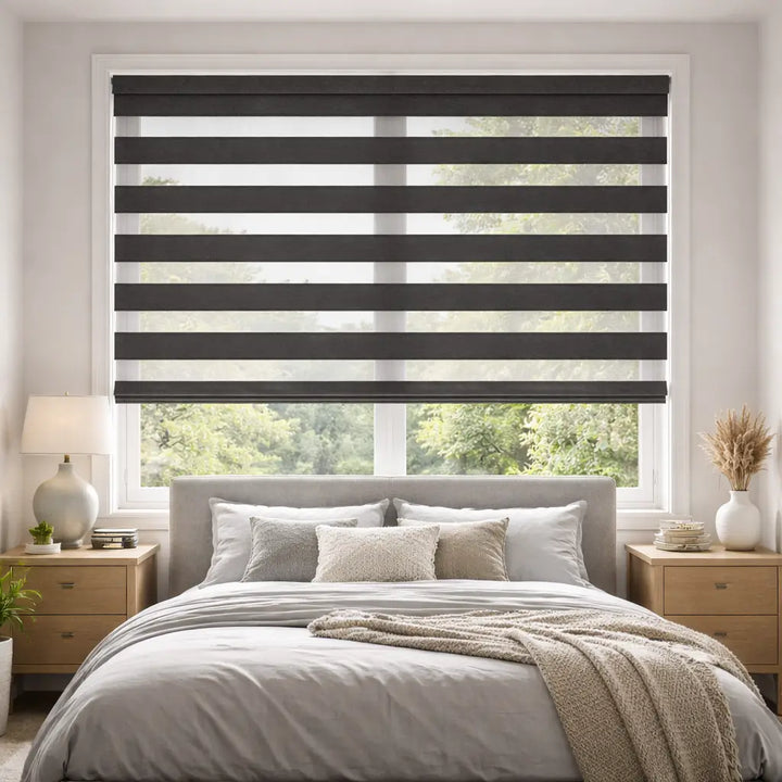 Bedroom with Charcoal Blackout Zebra Shades in the open position, allowing striped natural light.