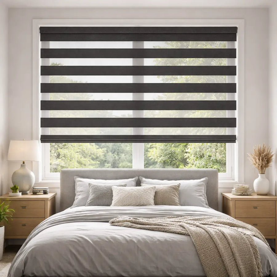 Bedroom with Charcoal Blackout Zebra Shades in the open position, allowing striped natural light.
